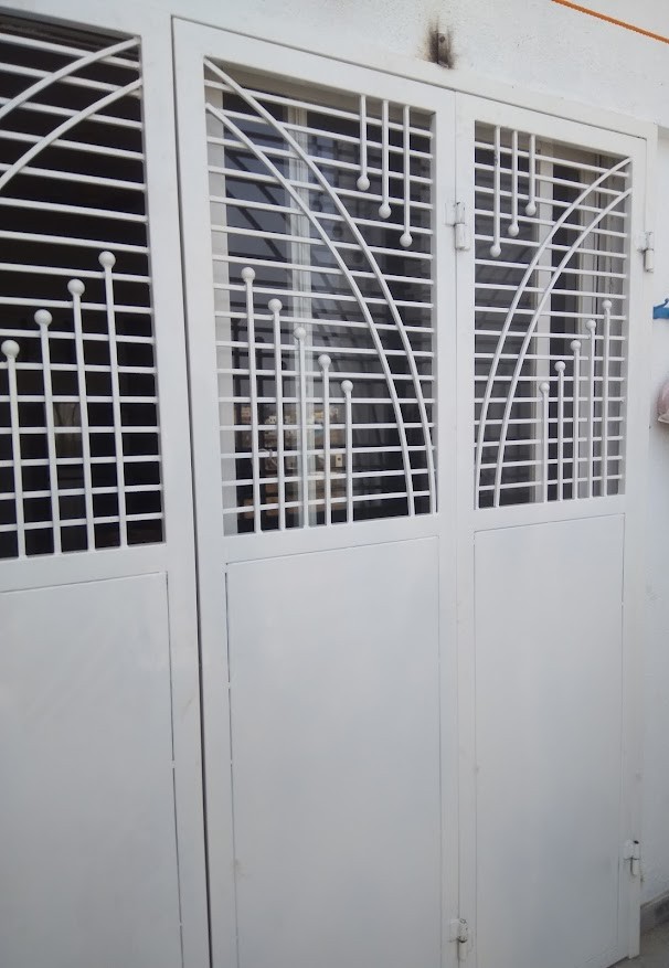 Modern MS sliding balcony door with glass panels for a high-rise apartment.